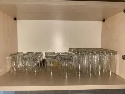 a row of clear glasses sitting on a shelf at Villa Keskin - Girne in Ayios Ioannis