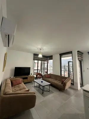 a living room with two couches and a flat screen tv at Moonlight Home in Nicosia
