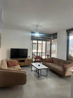 a living room with two couches and a flat screen tv at Moonlight Home in Nicosia