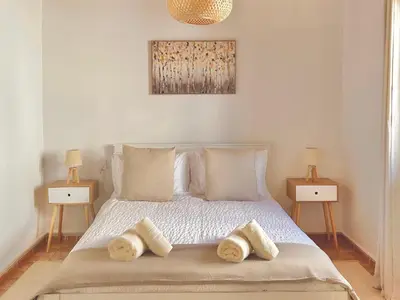 a bedroom with a bed with three pillows on it at Charming 1-BR Stay Near City Centre, Marina and Beaches - Perfect for Couples, Business or Solo Travellers in Limassol