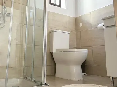 a bathroom with a toilet and a shower at Charming 1-BR Stay Near City Centre, Marina and Beaches - Perfect for Couples, Business or Solo Travellers in Limassol