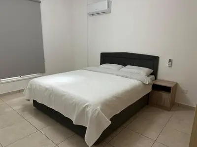a bedroom with a large bed and a television at 2 Bedroom Penthouse Apartment With Swimming Pool in Kiti