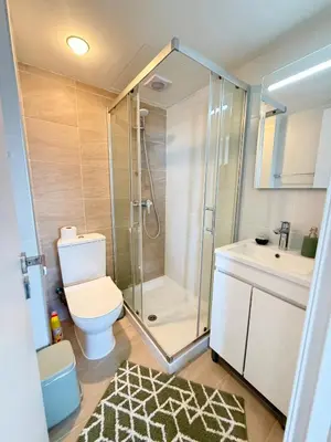 a bathroom with a shower and a toilet and a sink at Golden Nest by the Sea in Larnaka
