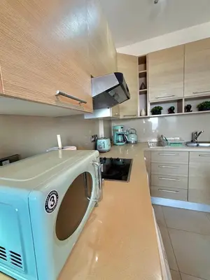 a kitchen with a washing machine on a counter at Golden Nest by the Sea in Larnaka