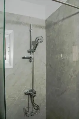 a shower in a bathroom with a glass door at TelMar Sky View in Larnaka