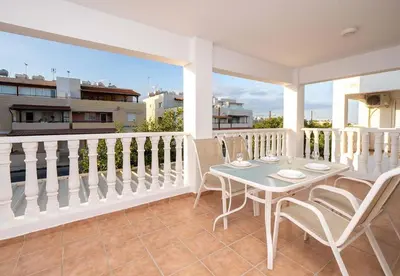 a patio with a table and chairs on a balcony at Stella's Little Island Gem in Paralimni