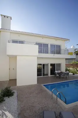 a house with a swimming pool in front of it at Villa Elise in Protaras