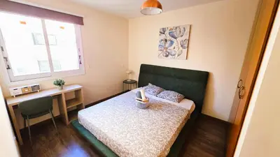 a small bedroom with a bed and a desk at Sunny 2BR Getaway Steps from the Beach with Wi-Fi in Larnaka