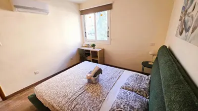 a bedroom with a bed and a window at Sunny 2BR Getaway Steps from the Beach with Wi-Fi in Larnaka