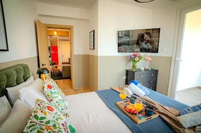 a room with a bed with a tray of food on it at New Central 2 bedroom Apartment in Limassol