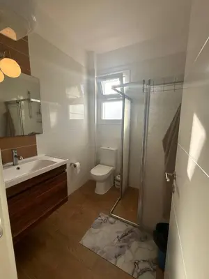 a bathroom with a sink and a toilet and a shower at Modern Smart-Home Studio Pools Gym Terrace View in Paralimni