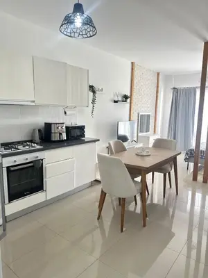 a kitchen with a table and chairs and a kitchen with a stove at Long Beach İskele - Caesar Resort Studio , Near Famagusta in Paralimni