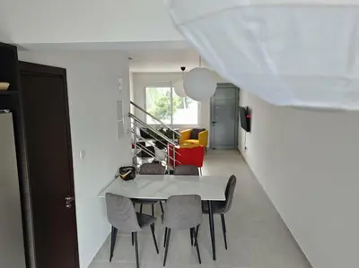 a dining room with a white table and chairs at Harmonia Home in Paralimni