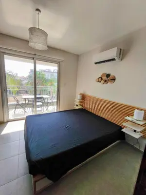 a bedroom with a large bed and a balcony at Harmonia Home in Paralimni