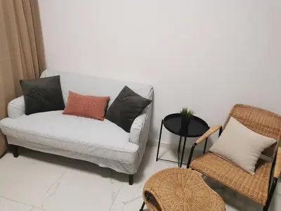 a living room with a couch and a chair at Lux studio apartment in Limassol