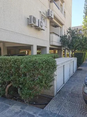 a building with a hedge in front of a building at Lux studio apartment in Limassol