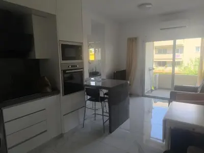 a kitchen with a counter and a stove top oven at Lux studio apartment in Limassol