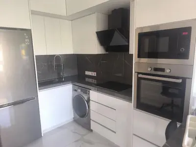 a kitchen with a microwave and a washer and dryer at Lux studio apartment in Limassol