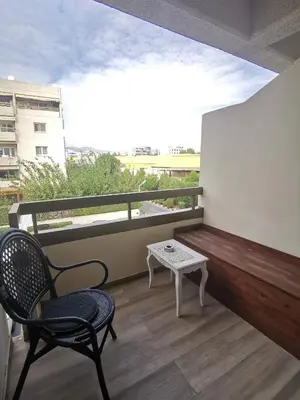 a balcony with a bench and a table and a chair at Lux studio apartment in Limassol