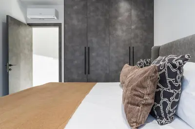 a bedroom with a bed with two pillows on it at Casino & Mall Luxury Jacuzzi Penthouse Suite in Limassol
