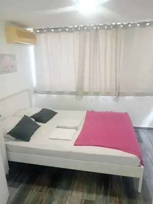 a white bed in a room with a window at Smart 2 Bedroom Flat in Larnaka