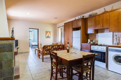 a kitchen with a table and a dining room at Mountain Retreat in Kyperounda