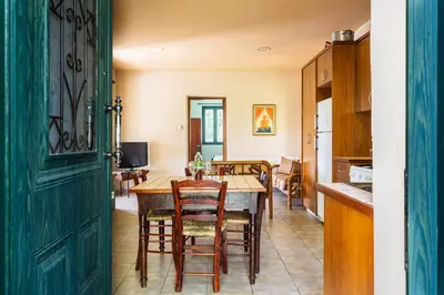 a kitchen and dining room with a table and chairs at Mountain Retreat in Kyperounda