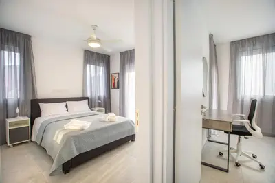 a bedroom with a bed and a desk and a chair at Two Bedroom House In Town Center by Sweet Keys in Limassol