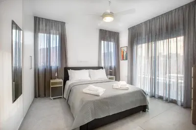 a bedroom with a bed with two towels on it at Two Bedroom House In Town Center by Sweet Keys in Limassol