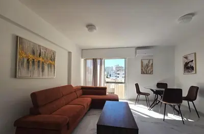a living room with a couch and a table at City Heart Residence by Staycom in Nicosia
