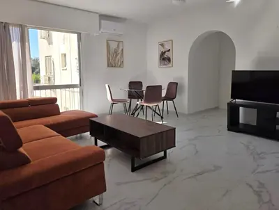 a living room with a couch and a table at City Heart Residence by Staycom in Nicosia
