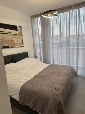 a bedroom with a bed and a large window at Modern Marvel Seaview in Paralimni