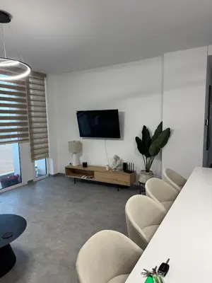 a living room with chairs and a flat screen tv at Modern Marvel Seaview in Paralimni
