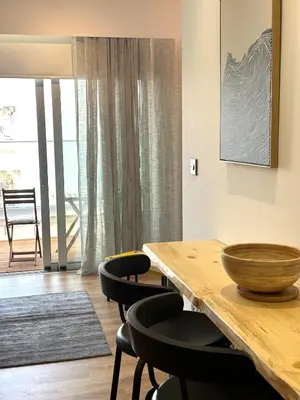 a dining room with a wooden table and chairs at Zeus Downtown Hub with Panoramic View in Nicosia