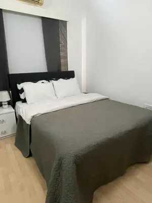 a bedroom with a large bed with white pillows at Famagusta Guest House in Mağusa