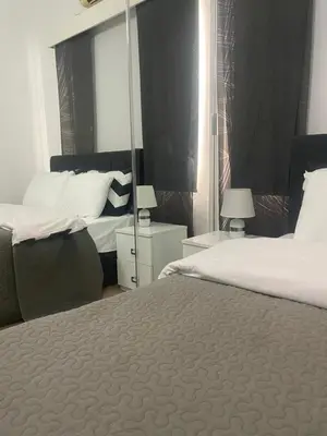 a hotel room with two beds and a mirror at Famagusta Guest House in Mağusa