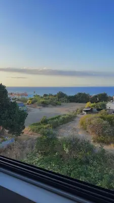 a view of the ocean from a train window at Centrally located studio with Mountain & Sea views in Avdhelleron