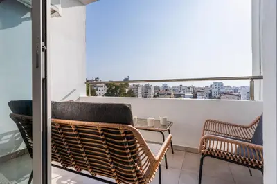 a balcony with a table and chairs and a window at Sonic 2-Bedroom Apartment in Larnaka