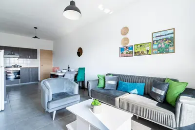 a living room with a couch and a table at Sonic 2-Bedroom Apartment in Larnaka