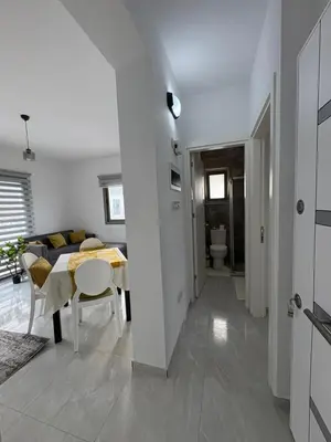 a dining room and living room with a table at Lapta Yellow 1 bedroom in Limassol
