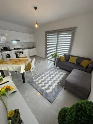a living room with a couch and a table at Lapta Yellow 1 bedroom in Limassol
