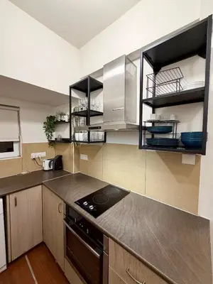 a kitchen with stainless steel cabinets and a stove at Relax Beach Apartment in Larnaka