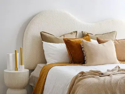 a bedroom with a large bed with brown and white pillows at Sanders Soul Apartments - Full Building in Limassol