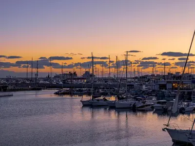 a group of boats docked in a marina at sunset at Sanders Soul Apartments - Full Building in Limassol