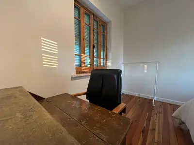 a desk and a chair in a room with a window at 1947 Rescued Stone House in Nicosia