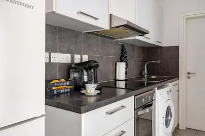 a kitchen with a sink and a stove at Cozy beachfront gem with seaview in Limassol