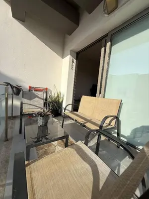 a balcony with two chairs and a glass window at Central Nicosia Haven in Nicosia