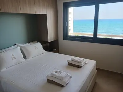 a bedroom with a bed with two towels on it at Lazuli Sea View & Pool Ap 502 in Larnaka