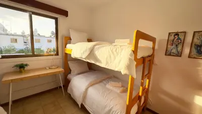 two bunk beds in a room with a window at SundyBeach Beachfront 2Bdr Dhekelia in Larnaka
