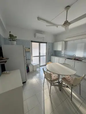 a kitchen with a table and chairs in a room at Ellados in Strovolos